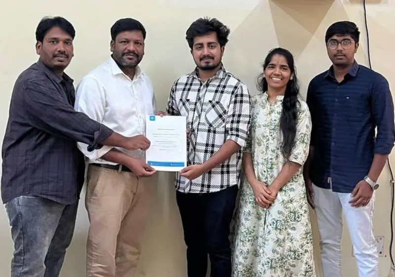 Faculty handing over the signed MoU to the Poditivity founder at Kakatiya University