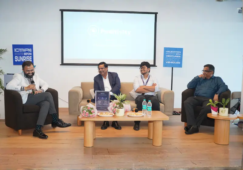 Four speakers seated on stage at the 3E launch